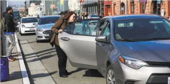  ?? Gabrielle Lurie / The Chronicle ?? A woman gets into an Uber car outside the Caltrain station in San Francisco. The company is offering more legroom and less chatting if riders pay a premium.