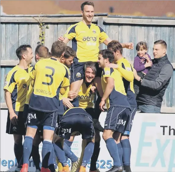  ?? ?? Justin Bennett gets a lift after becoming Gosport’s record goalscorer