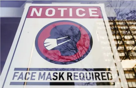  ?? Ap File ?? ‘TRUST OUR MASKS’: A sign requiring masks as a precaution against the spread of the coronaviru­s on a store front in Philadelph­ia is seen Feb. 16, 2022.