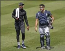  ?? KATHY WILLENS - THE ASSOCIATED PRESS ?? New York Yankees relief pitcher Aroldis Chapman, left, leaves the field after a bullpen session with catcher Gary Sanchez after a bullpen session during a baseball summer training camp workout Sunday, July 5, 2020, at Yankee Stadium in New York.