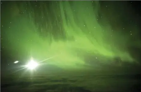  ?? (IAN GRIFFIN VIA AP ?? The Southern Lights are seen over the Southern Ocean near Antarctica from a chattered plane Friday. A charter plane that left Dunedin, New Zealand, late Thursday flew close to the Antarctic Circle to give the eager passengers an up-close look at the...
