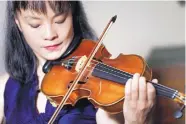  ?? SETH WENIG/ASSOCIATED PRESS ?? Mira Wang plays the Ames Stradivari­us violin in New York on Wednesday. After a meticulous restoratio­n, the violin will return to the stage on March 13.