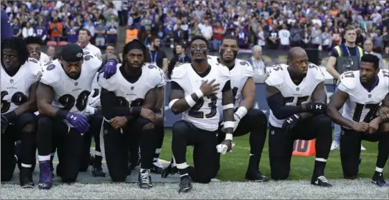  ?? MATT DUNHAM, THE ASSOCIATED PRESS ?? Baltimore Ravens players kneel during the playing of the U.S. national anthem before an NFL game against the Jacksonvil­le Jaguars at Wembley Stadium in London on Sunday.