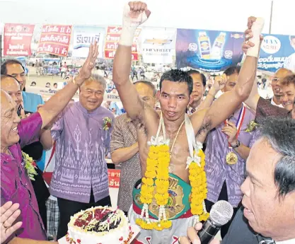  ??  ?? Thailand’s Teerachai Sitmorseng, centre, raises his arms in jubilation after winning an earlier bout.