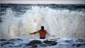  ?? AP PHOTO/GERRY BROOME ?? Body surfer Andrew Vanotteren, of Savannah, Ga., crashes into waves from Hurricane Florence, Wednesday, Sept., 12, on the south beach of Tybee Island, Ga. Vanotteren and his friend Bailey Gaddis said the waves have gotten bigger and better every evening as the storm approaches.