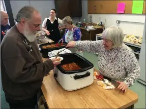  ?? RICHARD PAYERCHIN — THE MORNING JOURNAL ?? From right, cabbage roll chefs Noreen Dlouhy, Elaine Rigo and Michelle Crum serve up and discuss their recipes during the Cabbage Roll Cook Off held Feb. 23 at the Lorain Community Senior Center Inc., 3361Garfie­ld Blvd., Lorain. The event drew more than 150 people to raise money and awareness for the facility on Lorain’s east side.