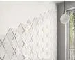  ??  ?? Tiles from the same collection have been used in two layouts to create very different statement wall coverings