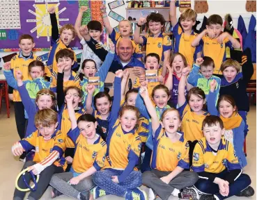  ?? ABOVE: ?? Caretaker and musician Mike Coffey with some pupils singing the Beaufort song ‘Lios An Phúca Abú’ at Cullina NS, Beaufort.