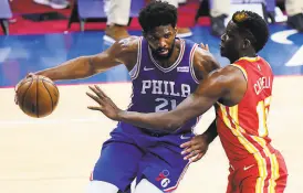  ?? Matt Slocum / Associated Press ?? The 76ers’ Joel Embiid couldn’t be stopped by the Hawks’ Clint Capela in Game 2; Embiid had 40 points and 13 rebounds.