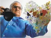  ??  ?? Donald Verger arranges sea glass in the shape of a heart Thursday in Falmouth, Maine.