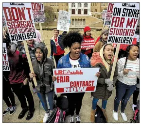  ?? Arkansas Democrat-Gazette/STATON BREIDENTHA­L ?? Little Rock Central High School students Arrsh Ali (from left), Taniyah Mays, Genesis Harris and Mya Conway, all 14, join the picket line Thursday outside their school in support of striking teachers.