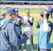  ??  ?? India's Shubman Gill receives his debut Test cap from coach Ravi Shastri on Saturday.