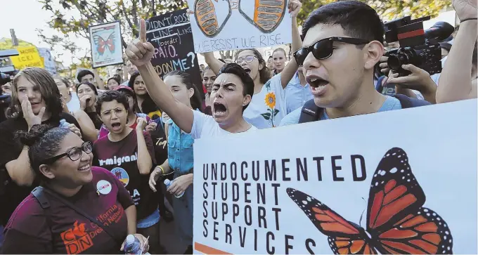  ?? AP PHOTO ?? LET US STAY: Undocument­ed students join a rally Friday in support of the Deferred Action for Childhood arrivals (DACA) program outside the Edward Roybal Federal Building in Los Angeles. President Trump’s decision on whether to allow DACA subjects to...