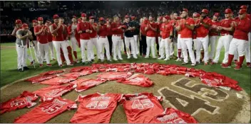  ?? MARCIO JOSE SANCHEZ — THE ASSOCIATED PRESS ?? Angels players place their jerseys with No. 45 in honor of pitcher Tyler Skaggs on the mound after a combined no-hitter against the Mariners on Friday in Anaheim, Calif. The Angels won, 13-0.