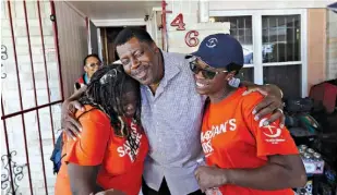  ?? AP Photo/David J. Phillip, File ?? George Dorsey, center, hugs Samaritan’s Purse volunteers Nikki Moore, left, and Samantha Roundtree, who were helping rebuild his hurricane-damaged home Nov. 17 in Houston. The groups helping to rebuild on the Texas Gulf Coast after Hurricane Harvey...