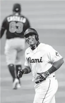  ?? IMAGES MARK BROWN/GETTY ?? Jesus Aguilar laughs towards the Rays dugout after just missing a home run in the ninth inning Thursday at loanDepot park.