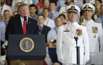  ??  ?? President Donald Trump (left), puts the USS Gerald Ford into commission as Ships commander Capt. Richard McCormack, front right, listens aboard the nuclear aircraft carrier USS Gerald R. Ford for it’s commission­ing at Naval Station Norfolk in Norfolk,...