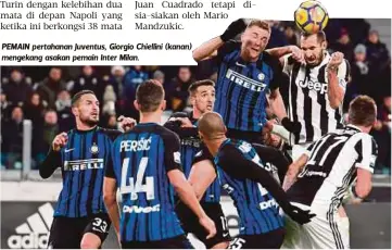 ??  ?? PEMAIN pertahanan Juventus, Giorgio Chiellini (kanan) mengekang asakan pemain Inter Milan.
