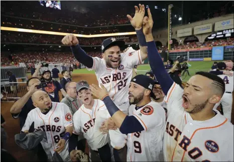  ?? AP PHOTOS ?? Houston Astros’ Jose Altuve is lifted by teammates after Game 7 of baseball’s American League Championsh­ip Series against the New York Yankees on Saturday in Houston.
