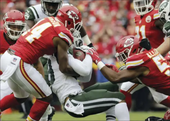  ?? CHARLIE RIEDEL — THE ASSOCIATED PRESS ?? Kansas City Chiefs wide receiver Demarcus Robinson (14) and linebacker D.J. Alexander (57) tackle New York Jets wide receiver Jalin Marshall (89) during the first half of an NFL football game in Kansas City, Mo., Sunday.