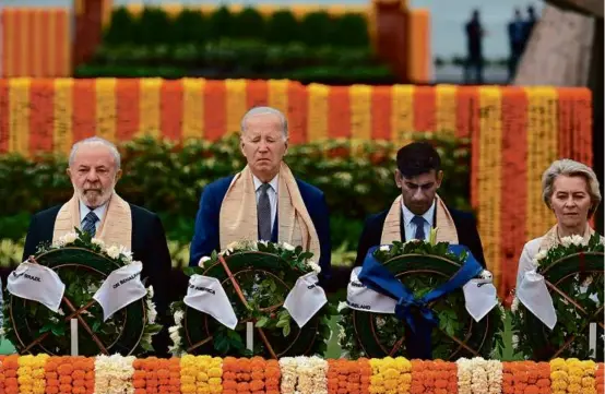  ?? KENNY HOLSTON/POOL ?? From left, Brazil President Luiz Inacio Lula da Silva, President Biden, UK Prime Minister Rishi Sunak, and European Commission President Ursula von der Leyen paid tribute at the Rajghat, a Mahatma Gandhi memorial, in New Delhi.