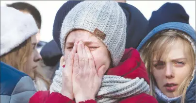  ?? AP PHOTO ?? A woman reacts after laying flowers for the victims of a fire in a multi-story shopping center in the Siberian city of Kemerovo, about 3,000 kilometers (1,900 miles) east of Moscow, Russia, Monday.