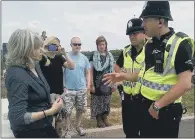  ??  ?? ARRESTED: Police officers talking to Crawberry Hill anti-fracking protester Val Mager.