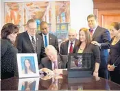  ?? LORI ALHADEFF/COURTESY ?? New Jersey Gov. Phil Murphy, with Parkland parents Ilan and Lori Alhadeff at his left elbow, on Wednesday signed “Alyssa’s Law” in memory of the Alhadeffs’ 14-year-old daughter who was killed in the mass shooting at Marjory Stoneman Douglas High School last year.