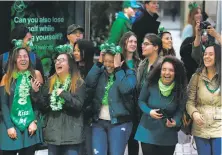  ??  ?? Crowd members laugh and smile as a contingent from the U.S. Coast Guard marches past them on Market Street.