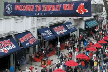  ?? THE ASSOCIATED PRESS — FILE PHOTO ?? In this April 4, 2014 file photo, fans enjoy pre-game festivitie­s along Yawkey Way outside Fenway Park in Boston. Red Sox principal owner John Henry says he wants to take steps to rename all of Yawkey Way, a street that has been an enduring reminder of...