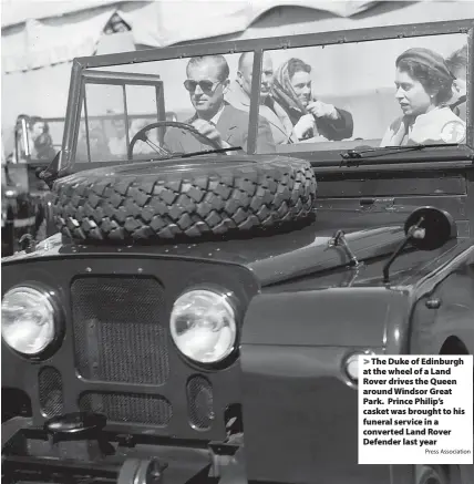  ?? Press Associatio­n ?? > The Duke of Edinburgh at the wheel of a Land Rover drives the Queen around Windsor Great Park. Prince Philip’s casket was brought to his funeral service in a converted Land Rover Defender last year