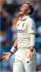  ??  ?? White out: Anderson is congratula­ted by his team-mates after the wicket of Pujara, while Curran (above) celebrates his first-ball dismissal of Bumrah