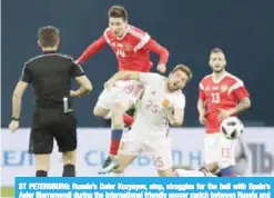  ??  ?? ST PETERSBURG: Russia’s Daler Kuzyayev, atop, struggles for the ball with Spain’s Asier Illarramen­di during the internatio­nal friendly soccer match between Russia and Spain in St Petersburg, Russia. —AP