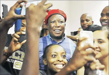  ?? Picture: COURTNEY AFRICA ?? SELFIE TIME: Stellenbos­ch University students pose for pictures with Economic Freedom Fighters leader Julius Malema after he addressed political science students yesterday.