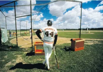  ?? Focus on Sport / Getty Images ?? During spring training in Phoenix in the mid-1970s, Giants first baseman Willie McCovey stands at the batting cage awaiting his turn to hit. McCovey spent 19 seasons with the Giants.