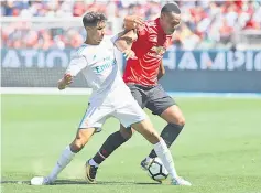  ??  ?? Anthony Martial (right) of Manchester United and Hakimi Achraf of Real Madrid go for the ball during the Internatio­nal Champions Cup match at Levi’s Stadium in Santa Clara, California. — AFP photo