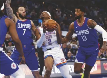  ?? NATE BILLINGS/AP ?? OKLAHOMA CITY THUNDER GUARD SHAI GILGEOUS-ALEXANDER (2) drives to the basket between Los Angeles Clippers guard Amir Coffey (7) and forward Paul George (13) during the first half of a game on Thursday in Oklahoma City.
UP NEXT