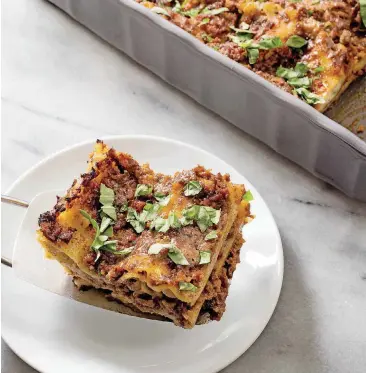  ?? TEST KITCHEN/AP] ?? This lasagna with ragu alla Bolognese recipe appears in the cookbook “Just Add Sauce.” [PHOTO BY CARL TREMBLAY, AMERICA’S