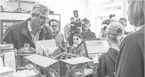  ??  ?? Gov. Eric Holcomb gets beer Sunday. MICHELLE PEMBERTON/INDIANAPOL­IS STAR