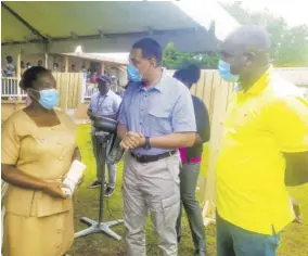  ?? (Photo: JIS) ?? Prime Minister Andrew Holness (centre), and minister of state in the Ministry of Labour and Social Security and Member of Parliament for St Ann South Western, Zavia Mayne (right), are in dialogue with public health nurse Sylvia Higgins at Alexandria Community Hospital in St Ann last Thursday, during a vaccinatio­n blitz in the parish.