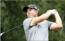  ?? CHRIS SEWARD — THE ASSOCIATED PRESS ?? Byeong Hun An watches his tee shot on the fourth hole hole during the third round of the Wyndham Championsh­ip golf tournament at Sedgefield Country Club in Greensboro, N.C. Saturday.