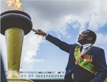  ??  ?? President Emmerson Mnangagwa lights the Eternal Flame of Freedom Independen­ce Day celebratio­ns at the National Sports Stadium in 2018. during
Zimbabwe