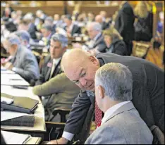  ?? BOB ANDRES / AJC ?? Sen. Mike Dugan pays a visit to lawmakers across the aisle in the House chamber on Tuesday, the 26th day of the 2017 Georgia General Assembly.