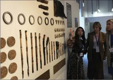  ?? (AP/Rafiq Maqbool) ?? Kadri Simson, European commission­er for energy, looks at a display of the impacts of war at the Ukraine Pavilion during the COP28 U.N. Climate Summit, Monday in Dubai, United Arab Emirates.