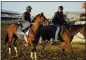  ?? JULIO CORTEZ — ASSOCIATED PRESS ?? Preakness entrant Epicenter, left, the runner up in the Kentucky Derby horse race, leaves the track after a workout ahead of the Preakness Stakes Horse Race race at Pimlico Race Course, Wednesday, in Baltimore.