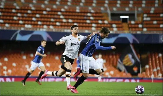  ?? UEFA VIA AP ?? Atalanta’s Hans Hateboer, right, vies for the ball with Valencia’s Goncalo Guedes during a Champions League round of 16 second leg match on Tuesday.