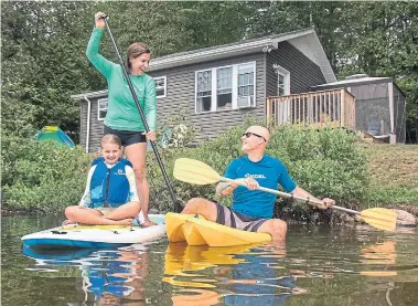  ?? FRED THORNHILL FOR THE TORONTO STAR ?? Ana and Rob Stephenson, along with daughter Addison, have moved to the Haliburton cottage they bought last summer.