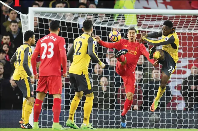  ??  ?? LIVERPOOL: Arsenal’s English striker Danny Welbeck (R) vies with Liverpool’s Brazilian midfielder Roberto Firmino (2nd R) during the English Premier League football match between Liverpool and Arsenal at Anfield in Liverpool, north west England...