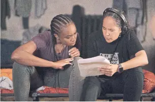  ?? AIMEE SPINKS NETFLIX ?? Actress Kiki Layne, left, and director Gina Prince-Bythewood discuss a scene while filming “The Old Guard.” The action film, also starring Charlize Theron, premieres Friday on Netflix.