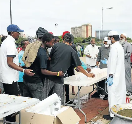  ?? Picture: Sandile Ndlovu ?? If it’s lunchtime it must be food from the Muslim community as people from four faiths in Durban work to feed homeless people.